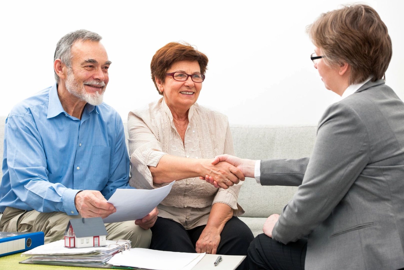 A man shaking hands with an older woman.
